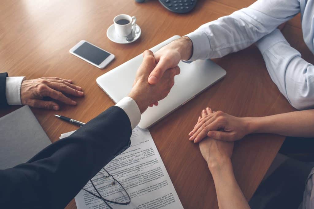 Young couple consultation with agent purchase rent property real estate handshake