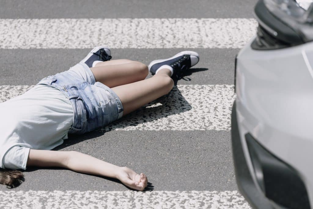 High angle on a child on a crosswalk hit by a car